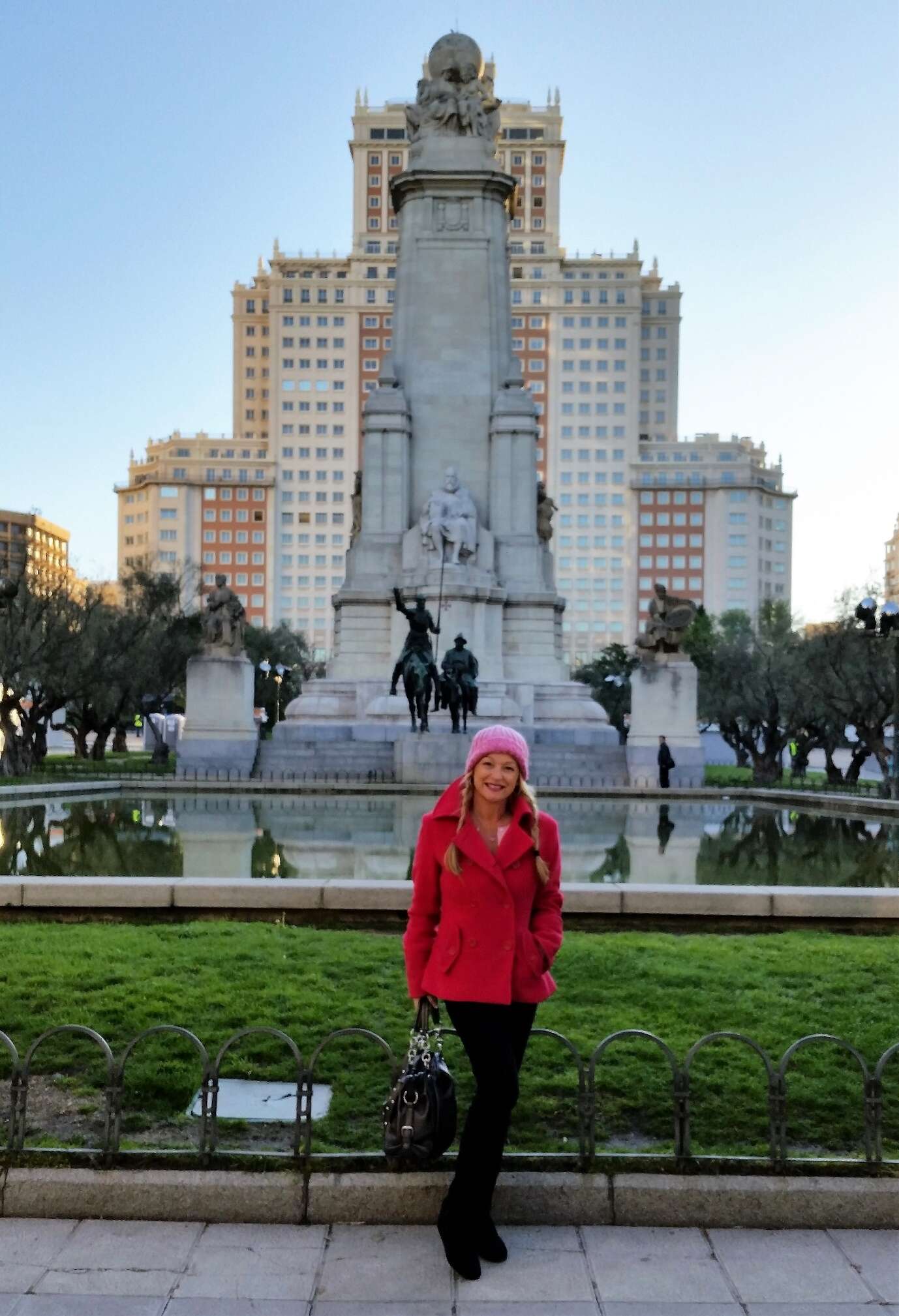 A person posing in front of a monument Description automatically generated