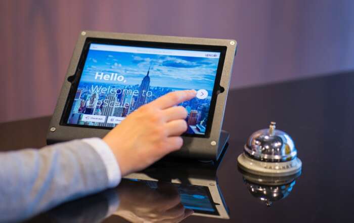 Tips and Hacks How to Book Lowest Price Hotel Rates A hand holding a tablet Description automatically generated with low confidence