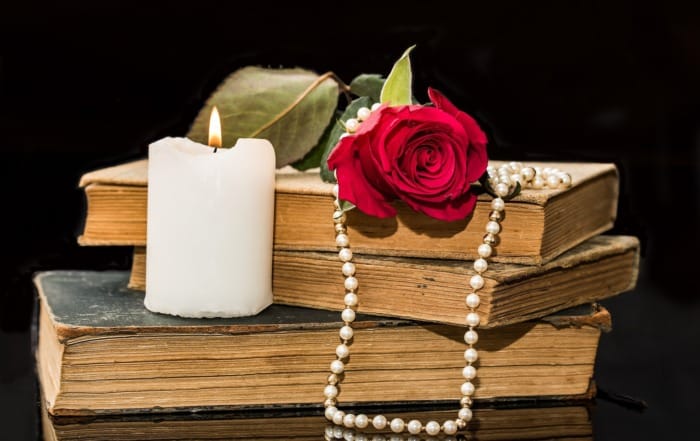 Page-Turning Love: Unique Travel Date Ideas in the USA for Book Lovers red rose books candle